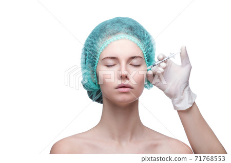 Portrait of young Caucasian woman getting cosmetic injection Portrait of young Caucasian woman getting cosmetic injection 71768553