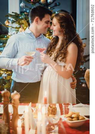 Couple celebrating Christmas, the wife is pregnant Couple celebrating Christmas, the wife is pregnant 71768602