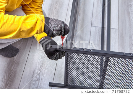 Mounting of metal frame of furniture from flat pack with screwdriver. 71768722