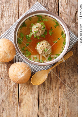 Liver Dumplings are a traditional Bavarian dish severd in a hot brooth close-up in a plate. Vertical top view 71768960