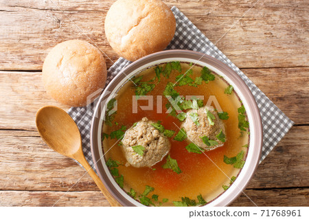 Homemade German broth with liver dumplings close-up in a plate. horizontal top view Homemade German broth with liver dumplings close-up in a plate. horizontal top view 71768961