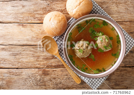 Tasty Liver dumplings added to broth make a wonderful authentic German soup close-up in a plate. horizontal top view 71768962