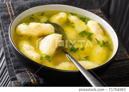 Recipe for Soup with Semolina Dumplings close-up in a plate. horizontal 71768965