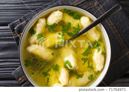 Recipe for Soup with Semolina Dumplings close-up in a plate. horizontal top view 71768971