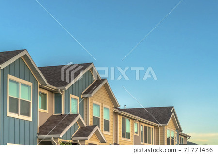 Exterior of upper storey of townhomes with blue sky background on a sunny day Exterior of upper storey of townhomes with blue sky background on a sunny day 71771436