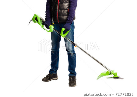 Man hold green grass electric trimmer indoors 71771825