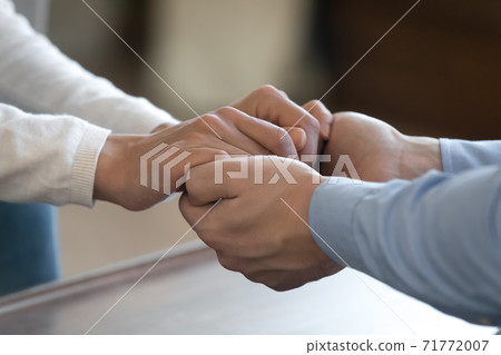 Young loving couple holding hands supporting comforting in difficult time 71772007