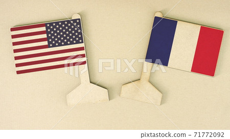 Flags of the USA and France made of recycled paper on the cardboard desk, flat layout 71772092
