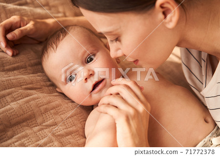Mother bent over her son 71772378