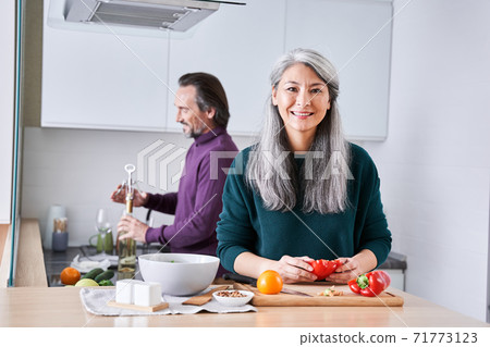 Couple is enjoying and preparing healthy meal 71773123