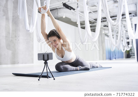 Woman looking at the camera with satisfied smile Woman looking at the camera with satisfied smile 71774322