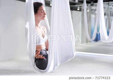 Woman sitting at the lotus pose Woman sitting at the lotus pose 71774323