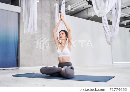 Woman doing yoga pose Woman doing yoga pose 71774663