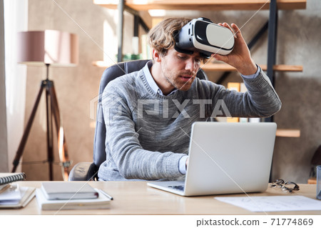 Man wearing glasses of virtual reality Man wearing glasses of virtual reality 71774869
