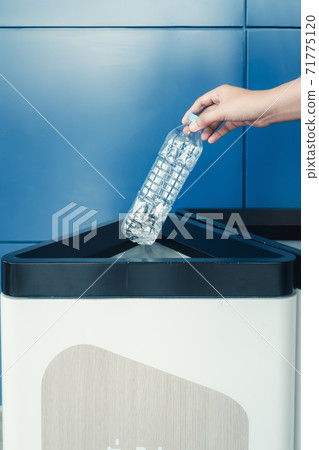 Save Green World and Care The Earth Concept, Close-Up Woman Hand is Throwing Plastic Bottle into Garbage Trash While Separating for Reuse and Recycle. Plastic Recycling for Care Environmental 71775120