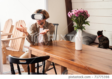 Man having video chat with pleasure using virtyal headset 71775398