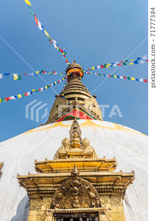 Tower of the Boudhanath Stupa decorated with flags in Kathmandu, Nepal. Tower of the Boudhanath Stupa decorated with flags in Kathmandu, Nepal. 71777384