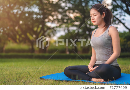 Asian woman meditating and sit at park, Healthy and Yoga Concept,Mind-body improvements concept, Selective focus, Copy space. Asian woman meditating and sit at park, Healthy and Yoga Concept,Mind-body improvements concept, Selective focus, Copy space. 71777499