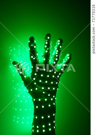 human hand covered with green led lights, illuminated background human hand covered with green led lights, illuminated background 71778316
