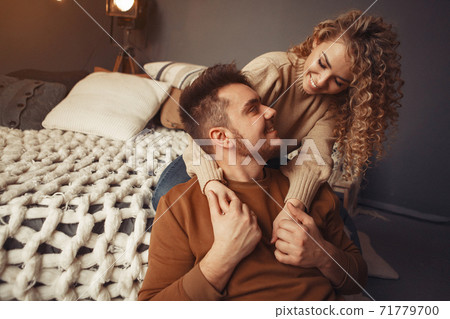 Elegant couple sitting at home near christmas tree Elegant couple sitting at home near christmas tree 71779700