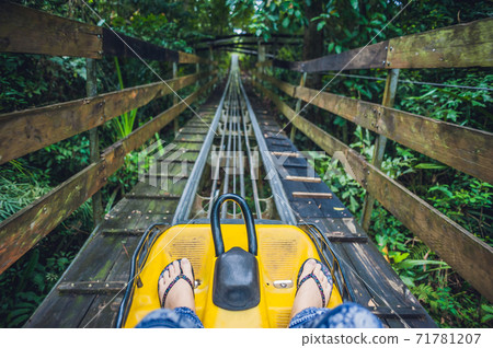 Feet of a young woman on Alpine Coaster 71781207