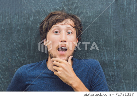Top view of a young man with space for text and symbols on the old wooden background. Concept for confusion, brainstorming and choice 71781337