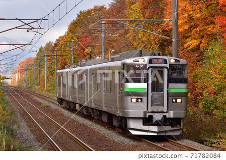 Train running on the Chitose Line in autumn colors 71782084
