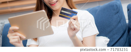 Hand of young asian woman holding credit card shopping online with tablet computer buying. Hand of young asian woman holding credit card shopping online with tablet computer buying. 71783231