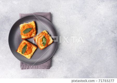 Sandwich with toast and zucchini caviar. Vegetable caviar on bread, a healthy vegetarian snack. Black plate copy space. Sandwich with toast and zucchini caviar. Vegetable caviar on bread, a healthy vegetarian snack. Black plate copy space. 71783277