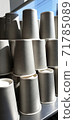 Many gray paper cups on a gray table 71785089