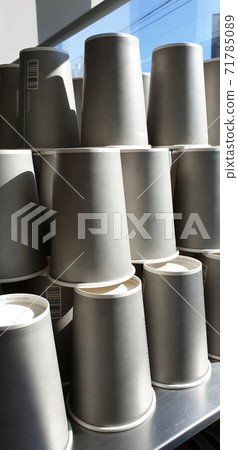 Many gray paper cups on a gray table Many gray paper cups on a gray table 71785089