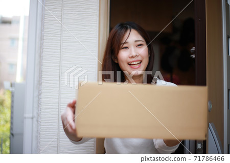 Woman receiving courier Woman receiving courier 71786466