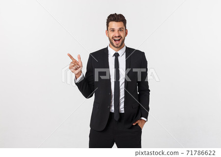 Portrait of young business man in suit pointing at copy space over white background. Portrait of young business man in suit pointing at copy space over white background. 71786622