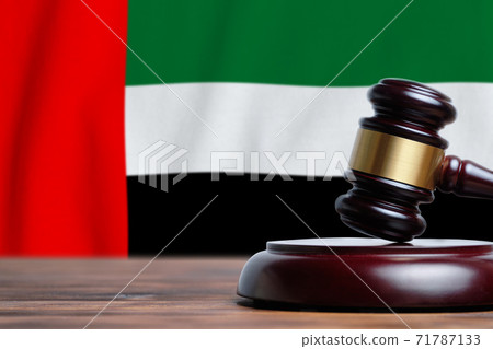Justice and court concept in United Arab Emirates. Judge hammer on a UAE flag background Justice and court concept in United Arab Emirates. Judge hammer on a UAE flag background 71787133