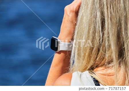 Smartwatch on the girl hand on the background of the sea Smartwatch on the girl hand on the background of the sea 71787157