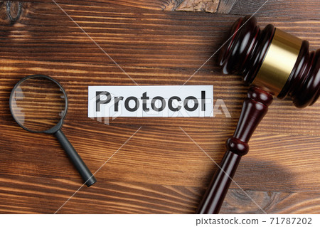 Concept of a court document as a protocol next to the judge magnifying glass and hammer 71787202