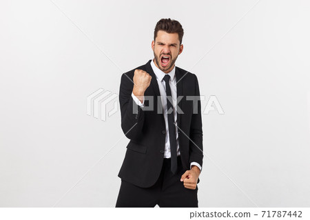 Portrait of a energetic young business man enjoying success, screaming against white - Isolated. 71787442