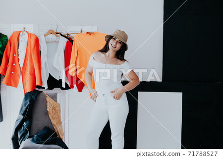 beautiful woman fits on a dress in the shopping mall beautiful woman fits on a dress in the shopping mall 71788527