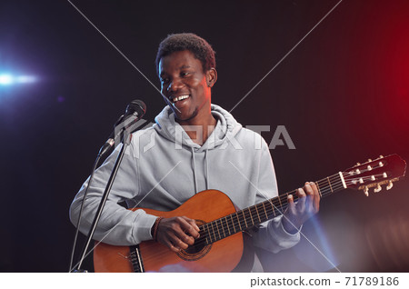 African-American Man Playing Guitar on Stage African-American Man Playing Guitar on Stage 71789186