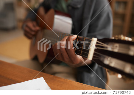 African-American Man Playing Guitar Close Up African-American Man Playing Guitar Close Up 71790743