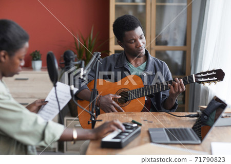 African-American Man Playing Guitar in Recording Studio African-American Man Playing Guitar in Recording Studio 71790823