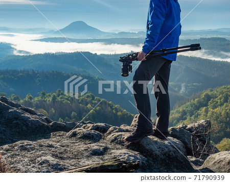 Man checking camera screen to see if his shot was a success. 71790939