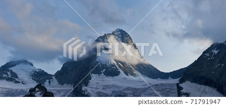 Beautiful mountain Dent Blanche in snow covered with grey clouds, Switzerland Beautiful mountain Dent Blanche in snow covered with grey clouds, Switzerland 71791947