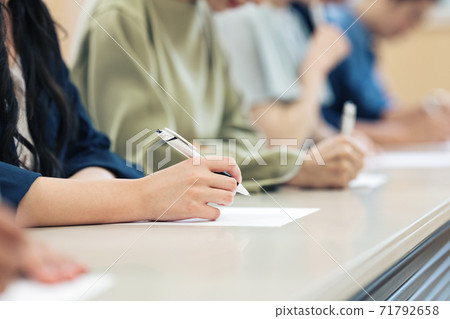 Hands of the person taking the exam 71792658