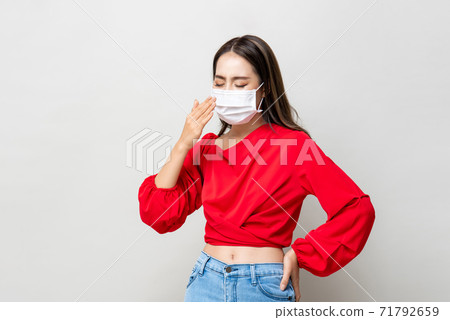 Asian woman wearing medical face mask coughing Asian woman wearing medical face mask coughing 71792659