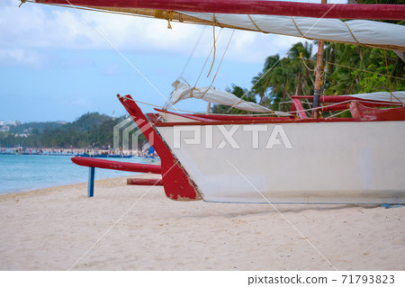 White beach of Boracay island. A sailing boat named Boracay is on the beach. Tourists walk along the beach and swim in the sea. A few days before the outbreak of the coronavirus. White beach of Boracay island. A sailing boat named Boracay is on the beach. Tourists walk along the beach and swim in the sea. A few days before the outbreak of the coronavirus. 71793823