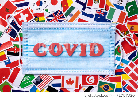 Medical masks with word covid written red colors on the background from national flags. Medical masks with word covid written red colors on the background from national flags. 71797320