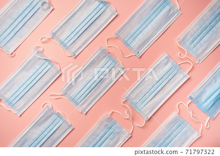 Blue medical protection face masks on the pink background for safety health. Blue medical protection face masks on the pink background for safety health. 71797322