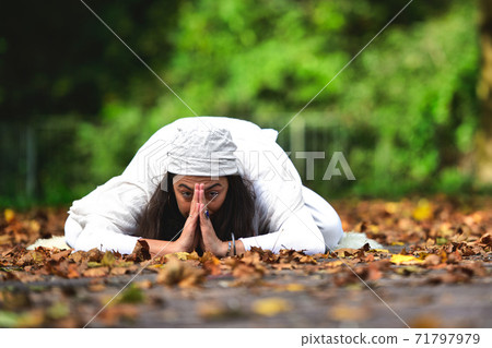 Yoga position among the autumn leaves in the park Yoga position among the autumn leaves in the park 71797979