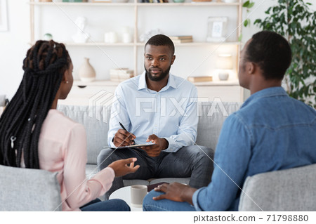 Professional Marriage Counselor Listening Problems Of Black Millennial Couple During Therapy Session Professional Marriage Counselor Listening Problems Of Black Millennial Couple During Therapy Session 71798880